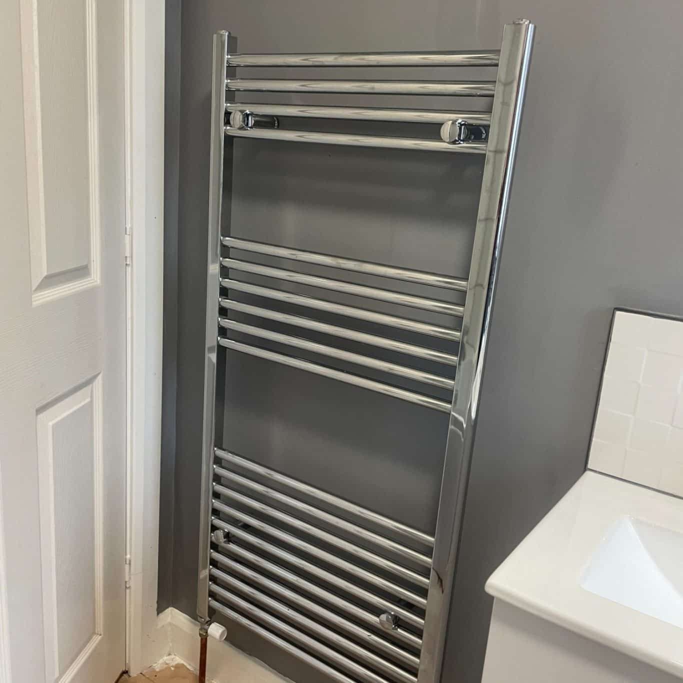 Professional New Radiator Fitting in Bath | Fixed Price Plumbing plumber from bath installing radiator